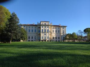 a large white house with a large field of grass at Vivila - Ca' Foulard in Cernusco sul Naviglio