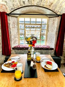 einen Tisch mit zwei Teller Essen und Orangensaft in der Unterkunft Royal William Yard Apartments - Large and Luxurious with Free Parking in Plymouth