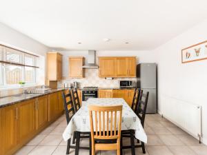 a kitchen with a table and chairs and a refrigerator at Pass the Keys Self Contained 2 Bed with Parking Leamington Spa in Leamington Spa