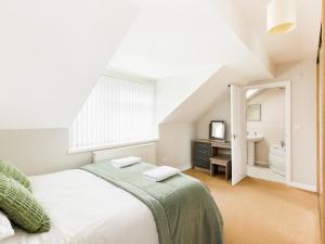 a white bedroom with a bed and a sink at Pass the Keys Self Contained 2 Bed with Parking Leamington Spa in Leamington Spa