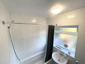a bathroom with a shower and a sink at Tranquil Charming Stay in Atherton