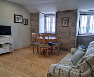 a living room with a table and a couch at Casa Recanto do Teatro in Lamego