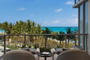 a view of the beach from the balcony of a resort at The St. Regis Bal Harbour Resort in Miami Beach
