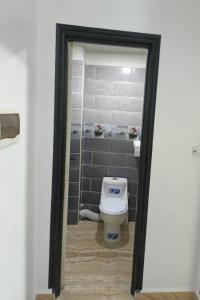 a bathroom with a white toilet in a room at Béjaïa 7 Jolis grands Apparts F3-F2 49-69e in Bejaïa +19 photos