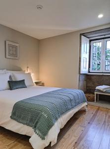 a bedroom with a large bed and a window at Casa Recanto do Teatro in Lamego +84 photos