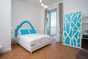 a bedroom with a bed and a large window at Relais al Castello in Castellammare di Stabia