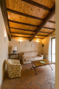 a living room with a couch and a table at Tenuta Agricola dell'Uccellina in Talamone