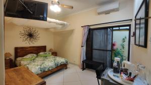 a bedroom with a bed and a sink in it at Maison Ambre Guesthouse in Windhoek