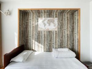 a bedroom with a bed with a wooden wall at Summit guest house in Ulaanbaatar