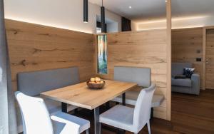 a dining room with a wooden table and chairs at Apartments Montblanc Seceda in Ortisei