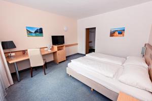 Habitación de hotel con cama y escritorio en Hotel Wiental en Pressbaum