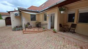 a patio of a house with chairs and a table at Milla Apartmanok in Eger +24 photos