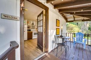 a kitchen with a table and chairs on a balcony at Pet-Friendly Mt Dora Apartment with Deck - Near Lake in Mount Dora