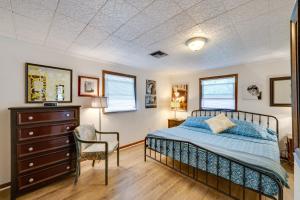 a bedroom with a bed and a dresser and a chair at Pet-Friendly Mt Dora Apartment with Deck - Near Lake in Mount Dora