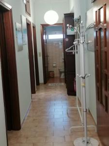 a hallway with a bathroom with a shower and a tile floor at Iliahtida in Chalkida
