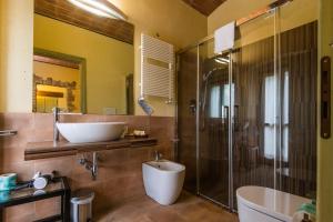 a bathroom with a tub and a sink and a shower at Tenuta Agricola dell'Uccellina in Talamone