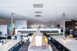 a restaurant with tables and couches and a bar at Hotel Schloss Montabaur in Montabaur
