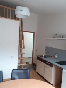 a kitchen with a sink and a ladder at Loft style apartments in Kaunas center in Kaunas