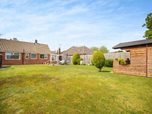 a yard with a house and a fence at Cyrabel in Boultham