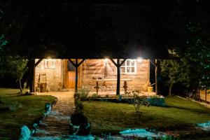 a stone house at night with a pathway leading to it at Magaze de Luxe in Gradačac