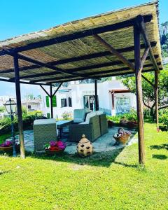 a wooden pergola with chairs and tables in a yard at B&B L'Agapanto in Capri