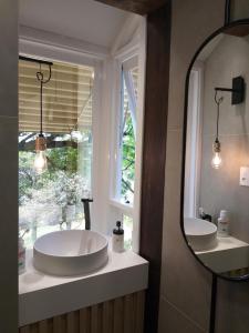 a bathroom with a large white tub and a window at Pousada Casa Thede in São Salvador