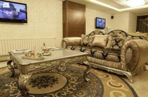 a living room with a couch and a table at SARR TAC MAHAL HOTEl in Ankara
