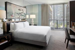 a bedroom with a white bed and a large window at W Miami in Miami
