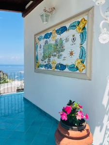 a map on the wall in a room with flowers at B&B L'Agapanto in Capri
