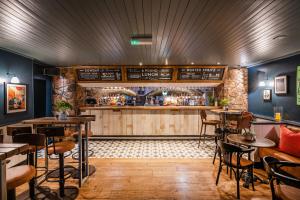 a restaurant with a bar with tables and chairs at The Clifton Hotel Bristol in Bristol