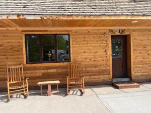 a cabin with two chairs and a table and a window at Creekside Downtown Vacation Suites, Only Adults 25 or older in Buffalo