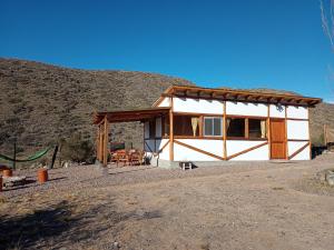 a small house in the middle of a mountain at Camino & Piedra - Cabaña de Montaña in Potrerillos