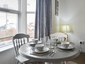 a dining room table with plates and glasses on it at Apartment 1 - Uk44165 in Bridlington