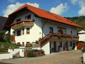 a large white house with an orange roof at Ferienwohnung Wilhelmi in Saarburg