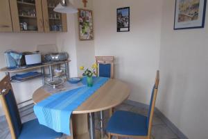 a table and chairs with a blue table cloth on it at Ferienwohnungen Wilhelmi in Saarburg