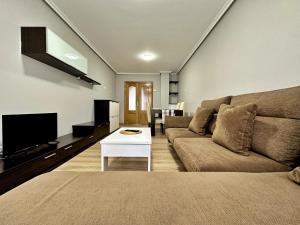 a living room with a couch and a tv at Abad Paterno - 3008 in Santoña