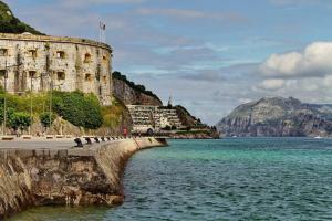 a castle by the water next to the ocean at Abad Paterno - 3008 in Santoña
