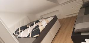 a bedroom with a bed with pillows on it at Joanna Apartment - Schwetzingen 3 in Schwetzingen