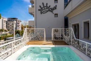 a hot tub on the balcony of a building at Royal Boutique Hotel in Riccione