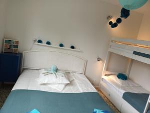 a bedroom with a white bed with a bow on it at GRAND T3 FAMILIAL 150m PLAGE LAVANDOU TOUT A PIED !!! PISCINE in Le Lavandou