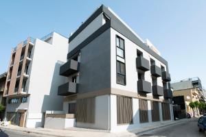 a black and white building on a street at Athena Studio in Gazi in Athens