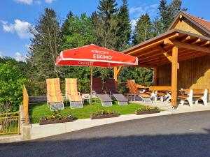 a patio with chairs and an umbrella and a table at Urlaub am Bauernhof Familie Kitting in Vorau