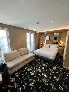 a hotel room with a bed and a couch at Hotel le 18 Paris in Paris