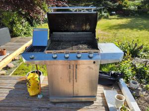 a grill sitting on top of a wooden deck at 6 Room Holiday House, Private Garden, Lego House, Legoland, Lalandia, in Billund