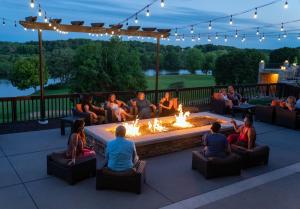 a group of people sitting around a fire pit at Grand Geneva Resort and Spa in Lake Geneva