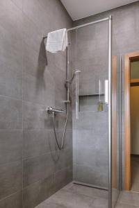 a shower with a glass door in a bathroom at Hotel Louis Müller in Bitburg