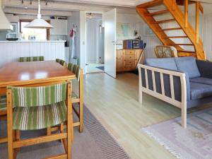 a kitchen and living room with a table and a couch at 6 person holiday home in Hadsund-By Traum in Hadsund