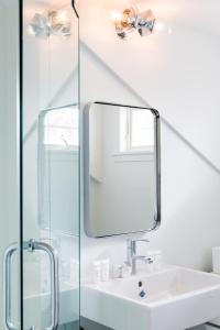 a bathroom with a sink and a mirror at The Christopher, The Edgartown Collection in Edgartown