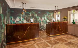 a room with two wooden booths with a mural on the wall at Flemings Mayfair - Small Luxury Hotel of the World in London