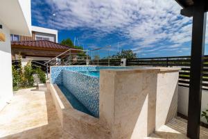 a swimming pool on top of a house at Modern 4-BR Villa with Pool in Punta Cana Residential Area in Punta Cana